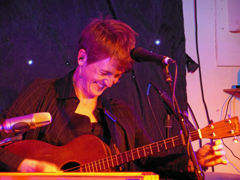 Photo of Karine Polwart laughing on stage in 2013